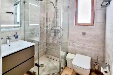 Modern bathroom with a glass-enclosed shower, a va