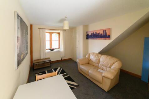 Bright, neutrally decorated living room featuri...