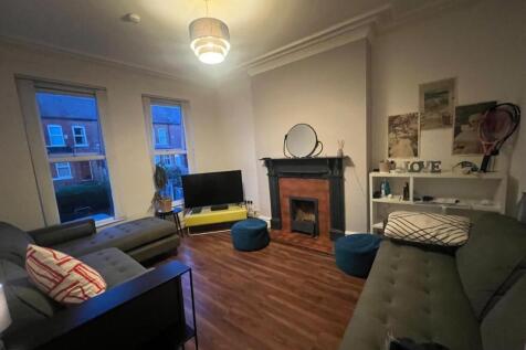 Comfortable living room with hardwood floors, d...