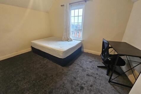 Simple, well-kept bedroom with a comfortable be...