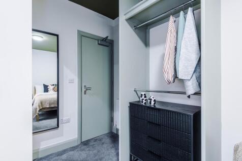 Bright, modern hallway with built-in open wardr...