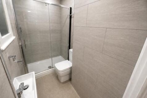 Modern tiled bathroom with sleek walk-in shower...