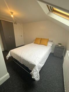 Bright, neatly presented bedroom with a comfort...