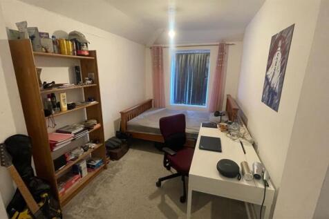Bright bedroom with ample storage and study des...