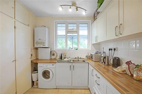 Bright kitchen with ample storage and laundry...