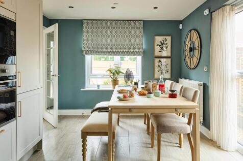 The dining area leads through double doors to the garden