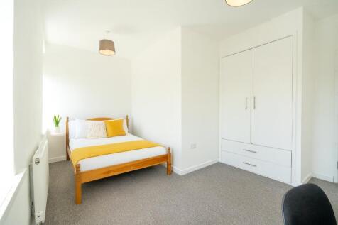 Bright, freshly decorated bedroom with a wooden...