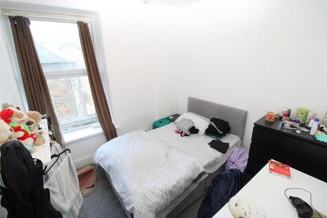 Bright bedroom with large window and double bed...