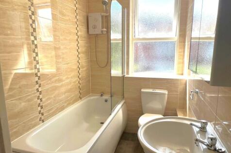 Bright, modern bathroom with a full bath and ov...