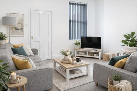 Bright, contemporary living room with matching ...