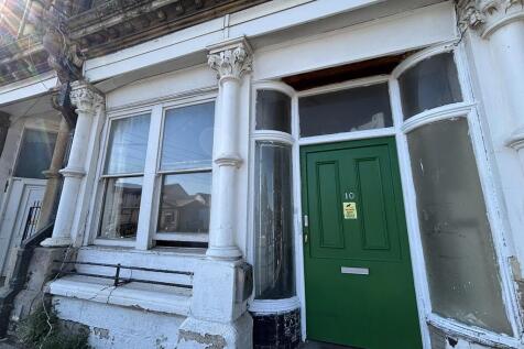 Charming period entrance with green front door...