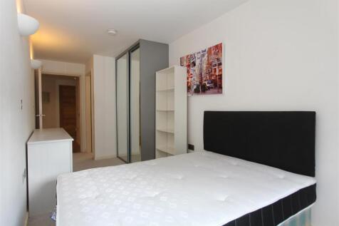 Bright modern bedroom with ample storage space...