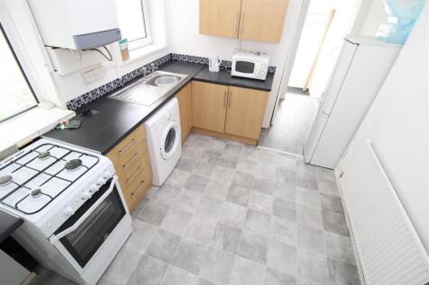 Bright kitchen with modern appliances and stora...