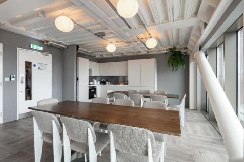 Modern communal workspace with ample seating...