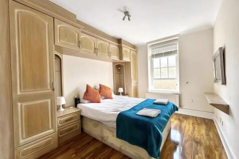 Bright bedroom with extensive built-in storage...