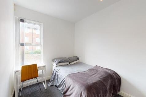 Bright, simply furnished bedroom with a single ...