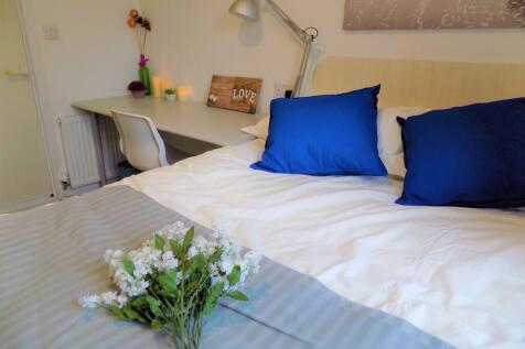 A cozy and neatly arranged bedroom featuring a ...