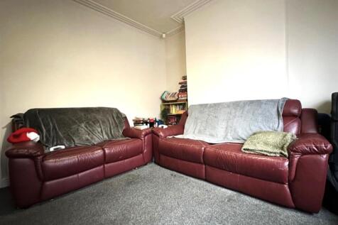 Bright, comfortable living room with two matchi...