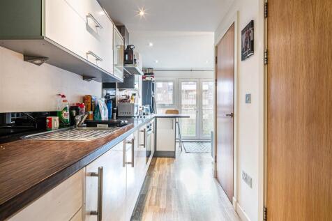 Bright modern kitchen with sleek white cabinets...