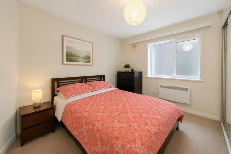 Bright double bedroom with comfy bed and storag...