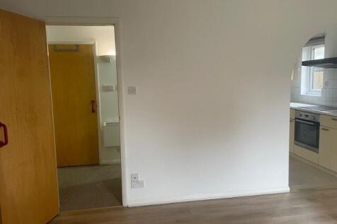 Bright, neutral living area with laminate floor...