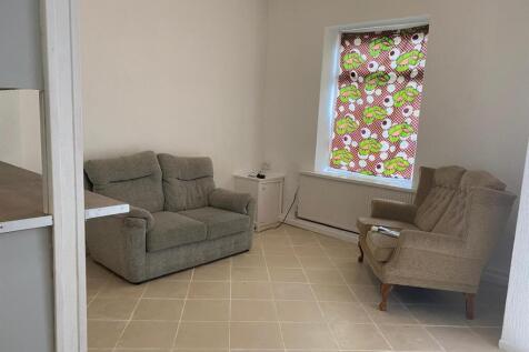 Bright lounge with comfortable seating and tili...