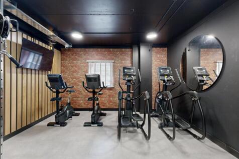 Modern gym with cardio machines and sleek decor...
