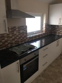 A tidy kitchen with modern fixtures and good li...