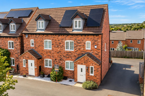 Sunny Brick Townhouses with Solar Panels.png