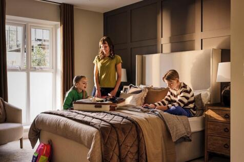 a person and a couple of kids on a bed