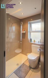 Modern bathroom with walk-in shower and window...