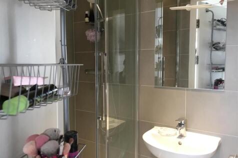 Modern bathroom with glass shower and sleek sin...