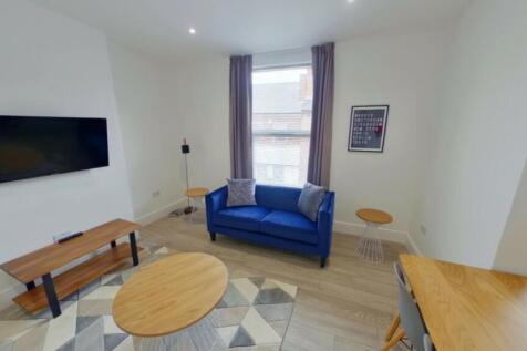 A bright and inviting large modern living room,...