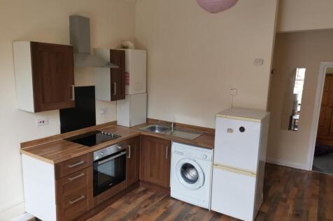 Bright kitchen with modern integrated appliance...