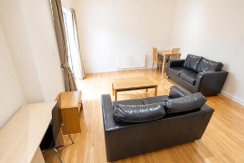 Bright, spacious lounge with sleek leather sofa...
