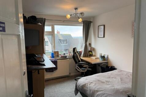 Bright, neatly presented bedroom with a large w...