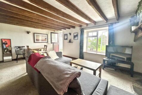 Charming lounge with exposed wooden beams...