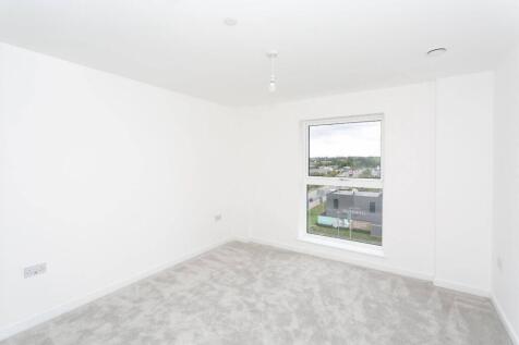Bright modern bedroom with plush grey carpet...
