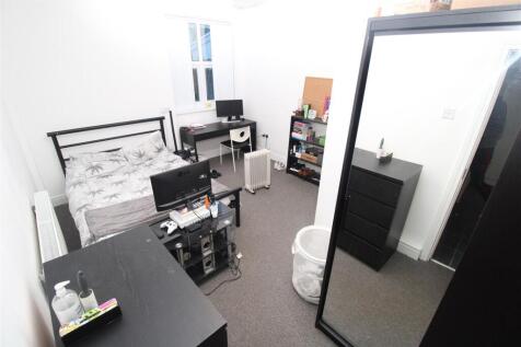 Bright bedroom with dual desks and double bed...