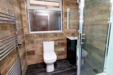 A modern bathroom featuring a sleek white toile...