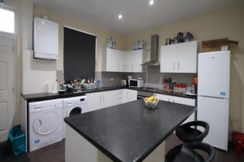 Modern kitchen featuring a central island with ...