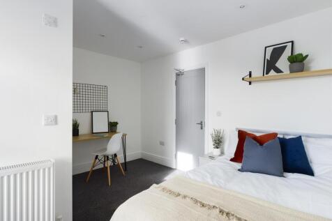 Bright, modern double bedroom with crisp white ...