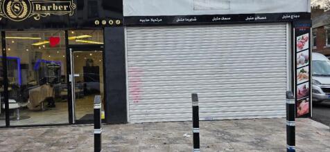 Shopfront with barber and roller-shutter unit...