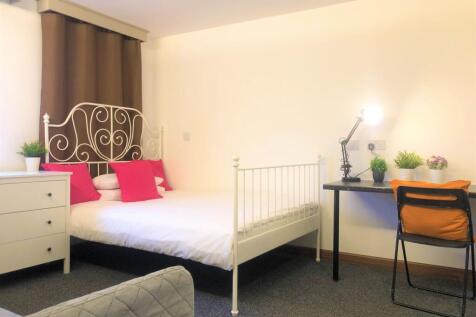 Bright and cozy double bedroom featuring an ele...