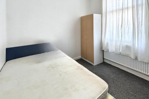 Bright and airy bedroom with large window...