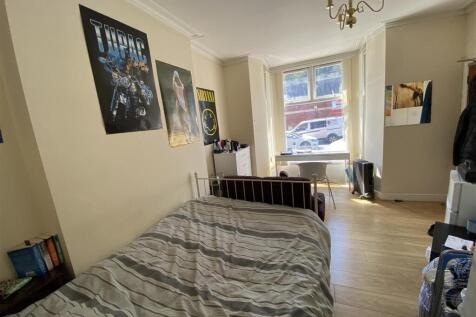 Bright bedroom with large window and study desk...