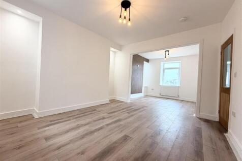 Bright, open-plan living area with wood floors...