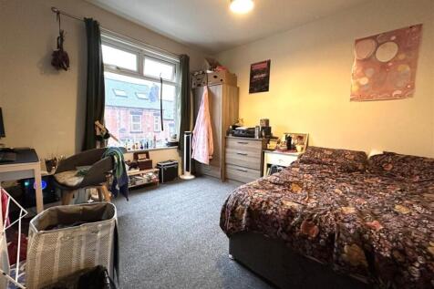 Bright, well-presented bedroom with a large win...