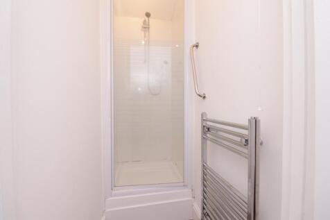 A clean and modern bathroom featuring a spaciou...