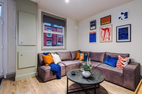 Bright, modern living room with an L-shaped sof...